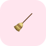 Straw broom with a wooden handle on a pale pink rounded background?